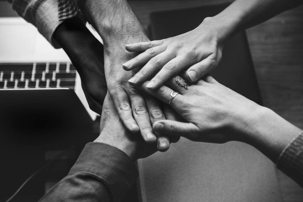 team of business people stacking hands